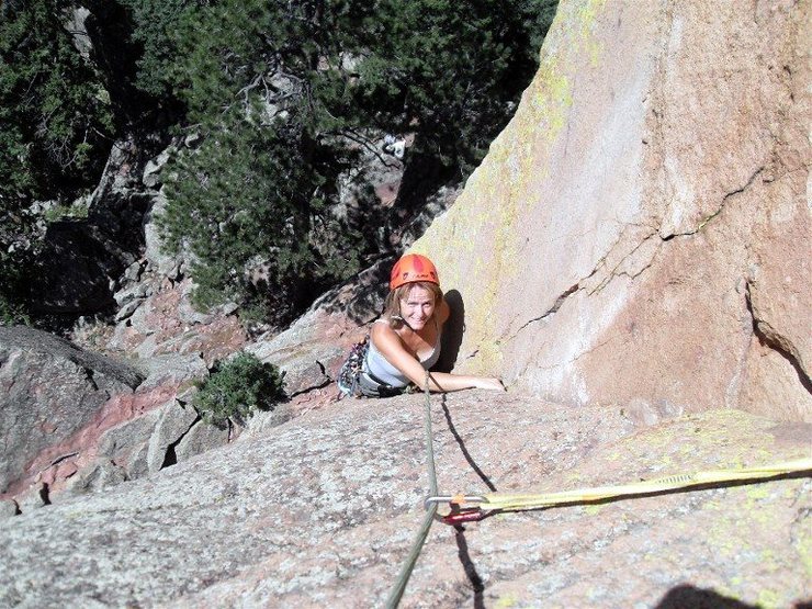 Brenda starting up the right-facing dihedral with the thin crack in the corner that comprises the last 10 feet of the climb to the eye bolts.