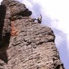 Erik top-roping <em>Black Market Organ Donor</em> (note ledge/nook at his feet, which contains evidence of raptor nesting)