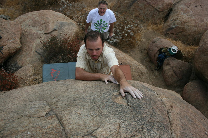 Nathan on the harder problem on a boulder.