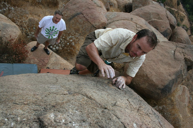 Nathan on the hardest problem on this boulder.