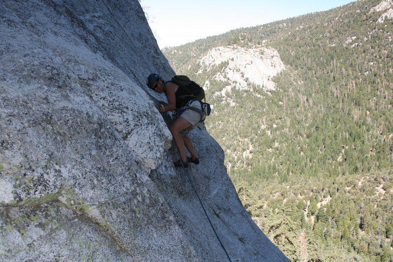 Agina stepping up into this fun move that gets you into the beautiful crack above. Hope that protection will hold.