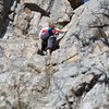 Top rope wall, three routes are between the  climber and the rope 5.2 - 5.3. Left and up of the climber in the shaded area is a 5.8 short dihedral climb.