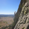 Unknown climber finishing Soler Eclipse. Taken from top of P1 on El Cracko.