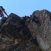 Setting the final bolts through the roof exit.  I tried to push the route further up the arete, but a huge, questionable flake and contrived climbing forced me to finish the line.  The finish exits the roof/corner just to the right of me, drill and hammer seen hanging from the last bolt.