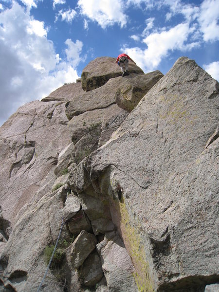 Contemplating a one of two muscly block moves on the left side of the SE arete.