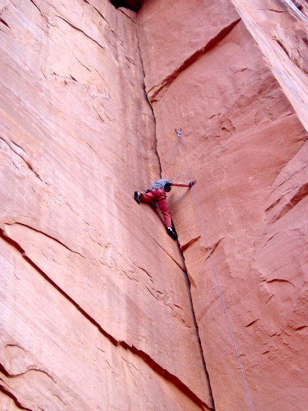 The second rest is on a 1" foothold on the left wall just below the anchors.