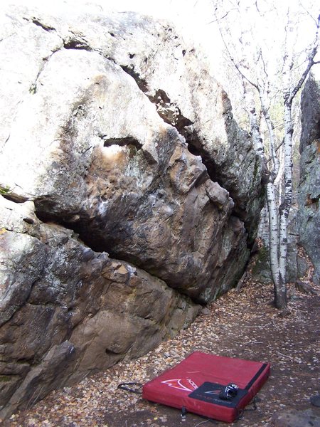 Anyone know any names/ratings  for the problems on this boulder? There are several fun ones including a traverse along the top horizontal crack.