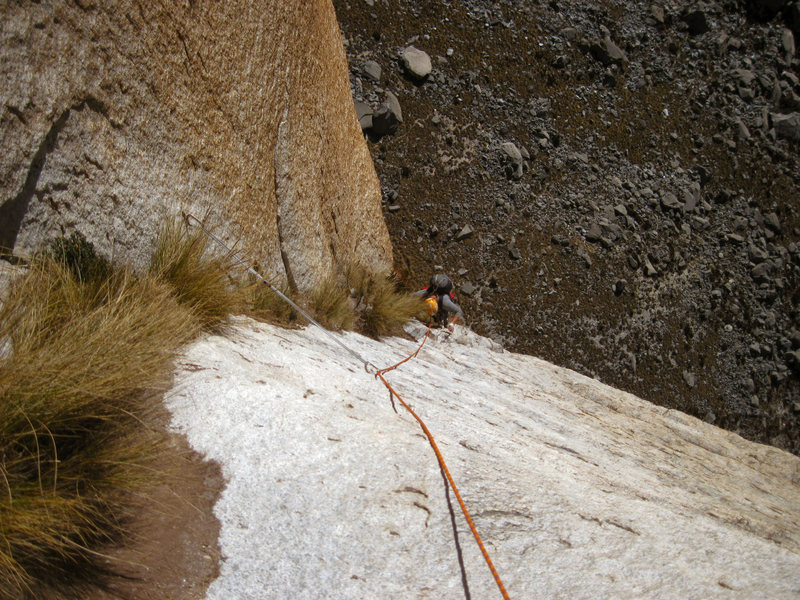 Andrew climbs through grassy cracks on the blob pitch.  The "blob" is seen at the bottom left hand corner of this photo.