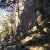 Looking down the cliff at main wall area, 5.10 cluster is the section at the trees.Bottom left is the free standing column. Group Grope wall is to the right of the free standing rock column.