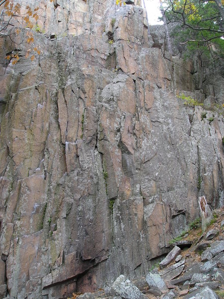 Cliff drifts upwards with unbolted rock face.Good 5.10 route potential past the "camp fire" stained rock.