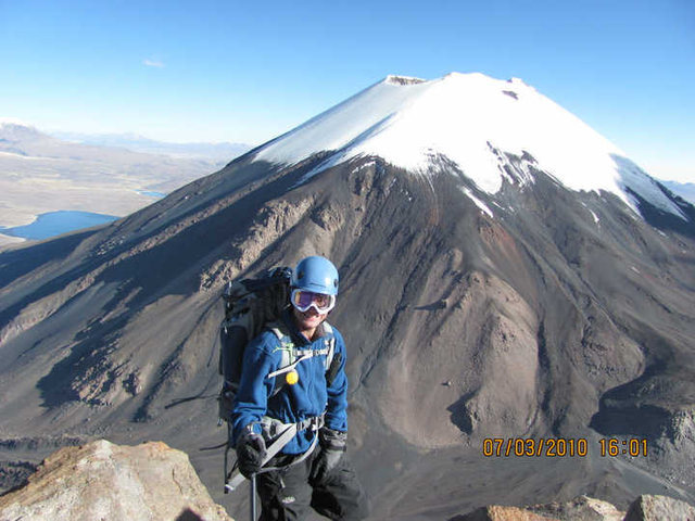 High up the South face of Pomerape with Parinacota behind