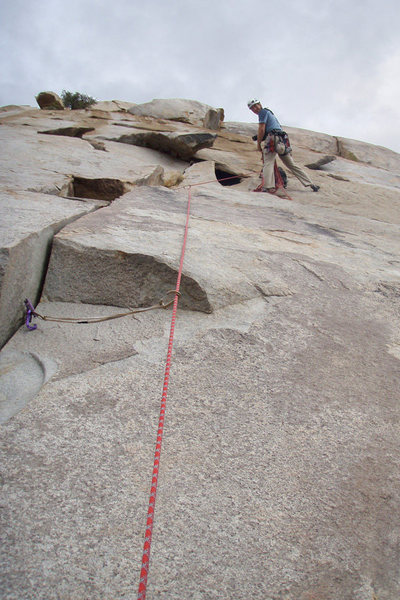 Matthew Fienup belays from the bolted anchor that is 160 feet up, atop Initiation Crack and Claustrophobia Crack.<br>
<br>
Photo by Romain Wacziarg