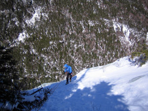 Jim rappelling the left end of the main wall; lower sunnyside is just visible on the right edge; the 100' center sunnyside flows look tiny from up here...