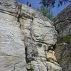 Rappelling is the access for this Skagway seacliff.<br>
<br>
Photo by Heather Slater<br>
Geoff Slater (head & knee) atop the wall.