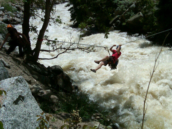 Crossing the river via the Tyrolean traverse. Boulder Creek was huge that day.<br>
