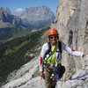 Easy climbing on ramps mid route. Gardena pass and Sassolungo (Langkolfel) in the background.