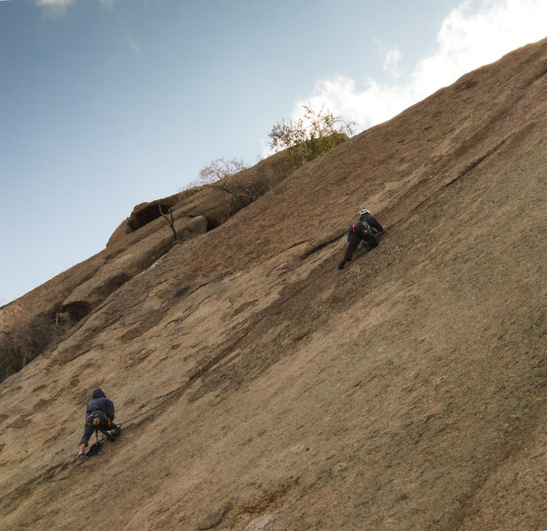 Doug leading away from the hanging belay.   The diagonal crack turns upward just out of view on the right.   