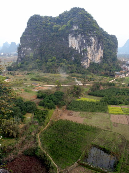 you can see the road coming in from the right, then turning left and coming up then at the left turn the trail approaches the wall.  Note: the trail does not go straight out to the road but hooks left in the photo.