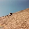 Scanned photo of myself working on bolting the climb. Photographer Jim Shimberg 