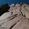 This pic is on the second pitch of the FA.  The line goes straight up to the small shadowed dihedral above and slightly to the right of me.  The first two pitches are 5.6-7.  Third is an awkward 5.9 zig zag to a belay under the roof at the base of the dihedral.  Don't forget you are at nearly 12,000 feet and will get tired fast if you haven't aclimatized.