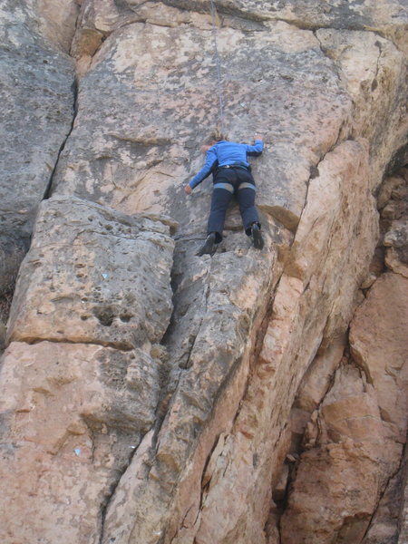 Beginning the crux boulder problem of Flamingo Lane.