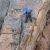 Beginning the crux boulder problem of Flamingo Lane.