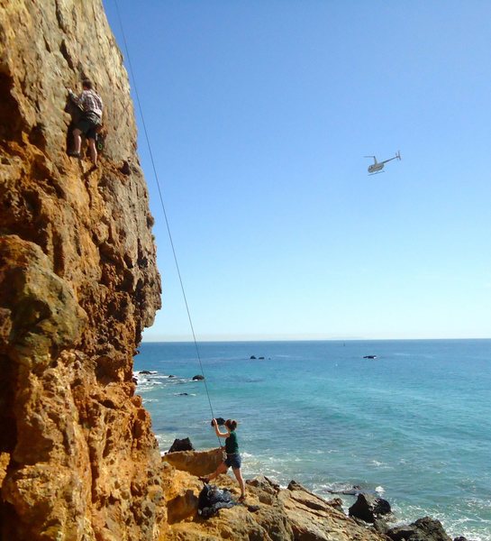 Typical occurrence at this crag: Random helicopters flying by all the time, dolphins swimming offshore, and cute girls doing bikini photo shoots in the rocks at the base. A great day at the beach if you don't mind washing ALL your gear afterward...