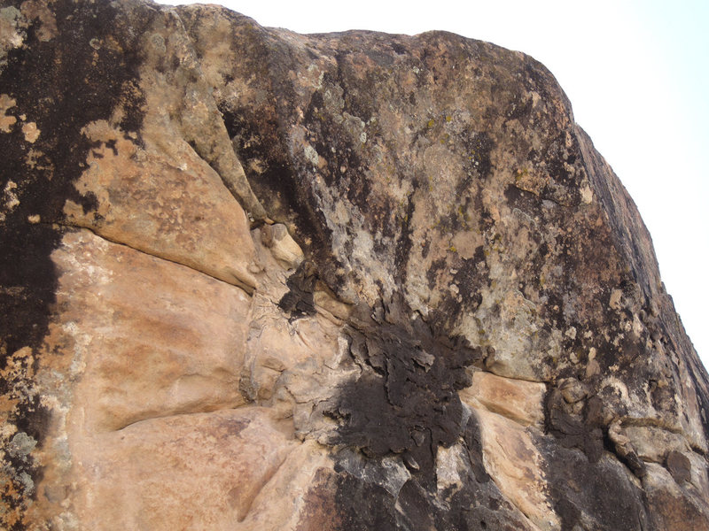 The distinctive shape in the rock we thought resembled a sun with extended rays, hence the New Mexico flag and the boulder's name.