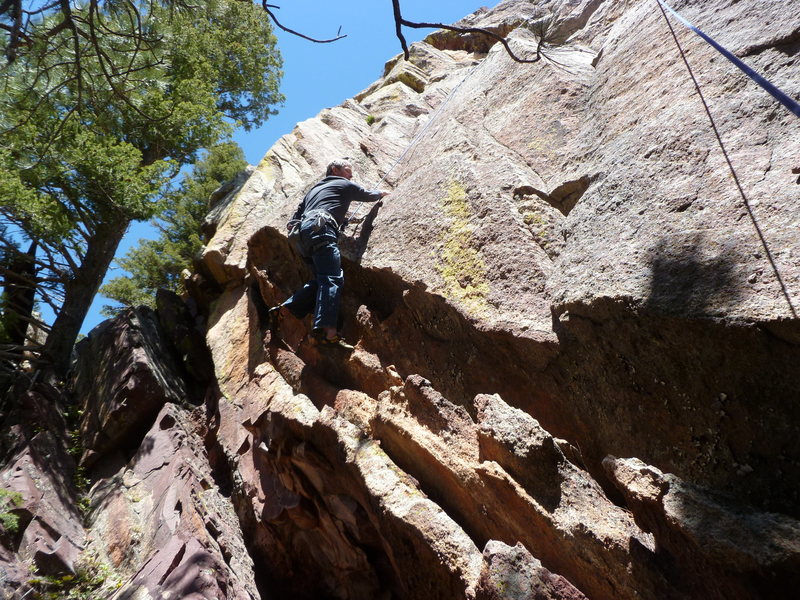 Moving over the roof is the first difficult move.  We chose to TR as there is no gear above the climber's feet.