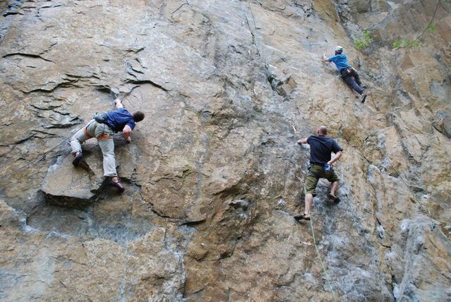 Michael Davis working the moves of Flippin' the Bird.<br>
<br>
 The climbers to the right are on Hinterland (middle; black shirt) and The Streak (right; white helmet).