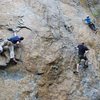 Michael Davis working the moves of Flippin' the Bird.<br>
<br>
 The climbers to the right are on Hinterland (middle; black shirt) and The Streak (right; white helmet).