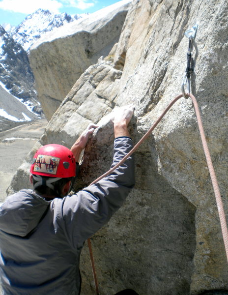 Austin Archer on the crux move, pitch 4, Three Hour Arete (5.10c).