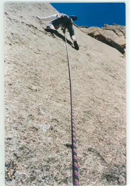 Clipping the first bolt from the anchors, starting the 2nd pitch.  A very windy April day made the runouts quite memorable.  Photo taken by crackthug, Devan Johnson.