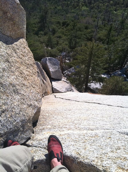 Looking down the dihedral nearing the top of P1. The 5.8 variation follows the thin fingercrack lieback up the dihedral and the original 5.7 follows the slanting crack to the left. Do the lieback :)