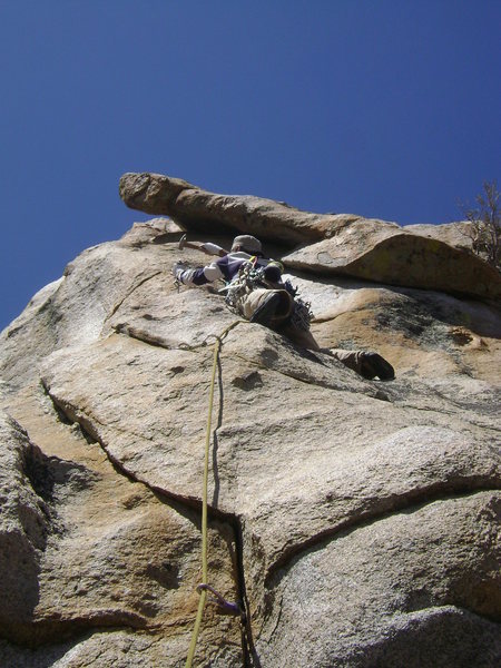 Installing the protection bolt on the first ascent of Just Face It.