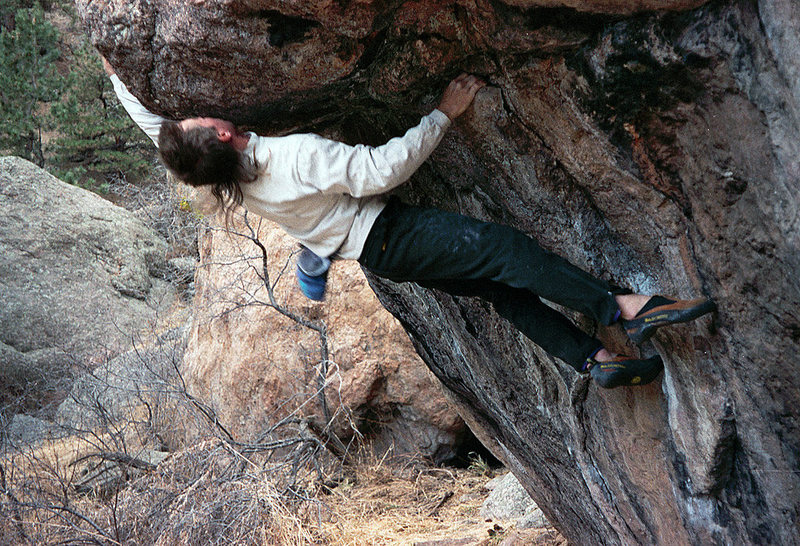 Sticking the big reach. The crux is controlling the swing as your feet cut loose.