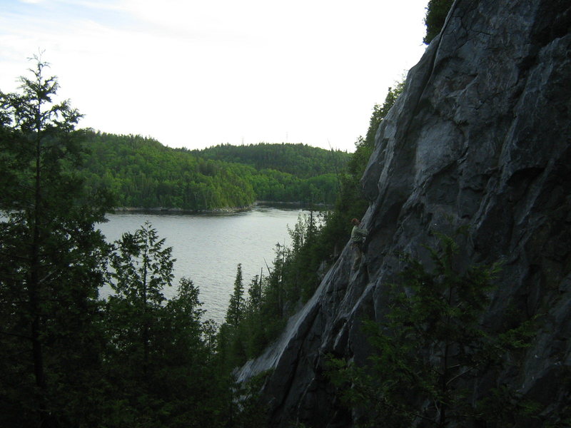 A climber about to move left on the face holds