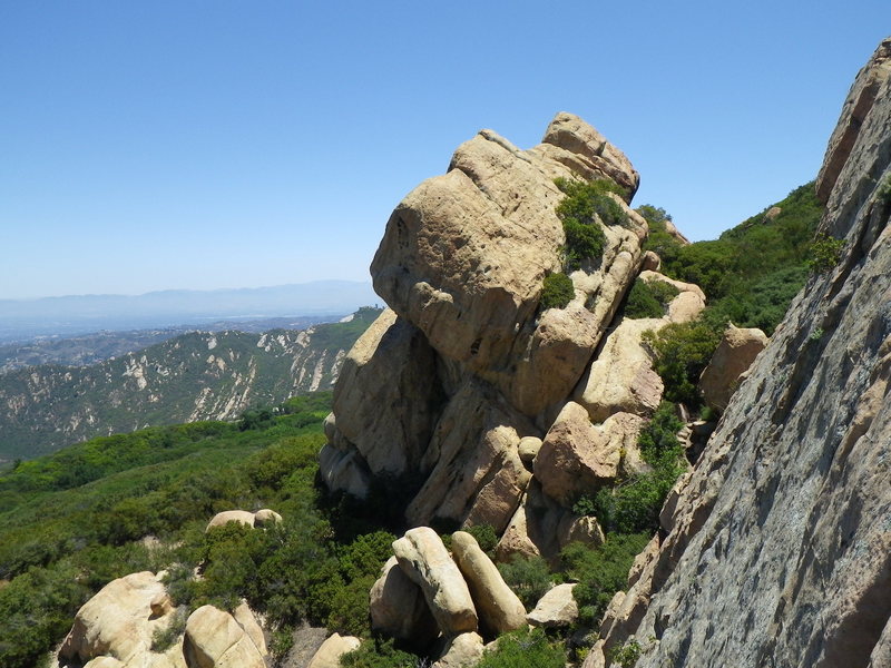 Giant rock next to the wall. Looks like there is an anchor on top. Anyone have any info?