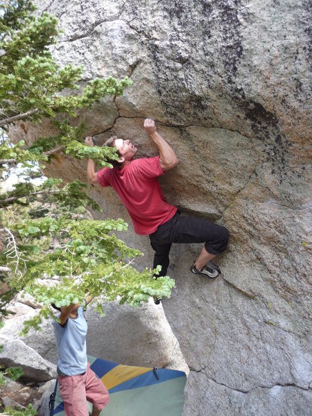 Going for the crux move on "Green Hornet" at Tram.