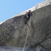 Travis Aiding through the Kor roof pitch on Skull Queen.