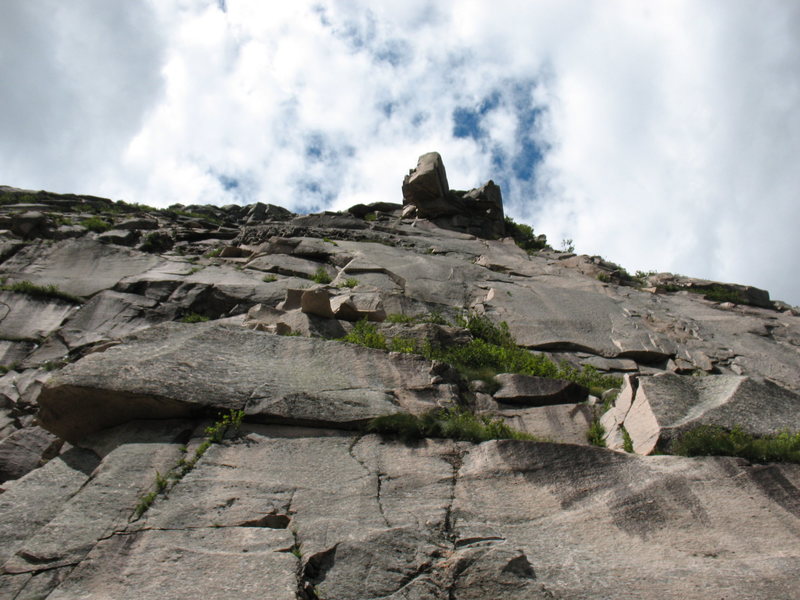 The climb starts on the right side of photo and finishes left of the overhang