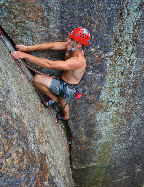 Scott Arno makes a clip while cruising into the easier terrain above the crux of Mr. Clean (5.9 - Barkeater Cliff - Adirondacks, NY)