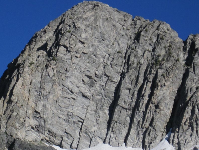 southeast face. the shadowy dihedral is worker bee (5.8) and the next two visible cracks to the left are the starts to the new world route (5.8). see the new SW Montana guidebooks for more beta. awesome alpine gneiss with a chill and scenic  approach. cant be beat