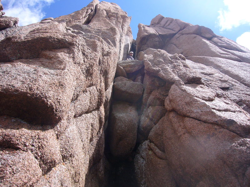 Top of Pitch 1 in west chimney.  Notice large chockstone and dark alcove behind.