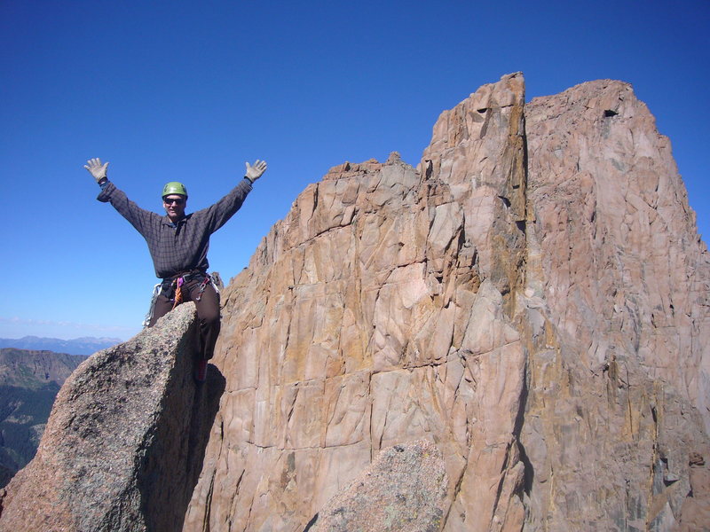 Steve Gladbach on the true summit with Peaks 16, 15, and Turret in distance.