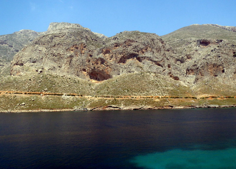 Arhi from across the bay.  Walls are to the left and right of the cave in the middle.