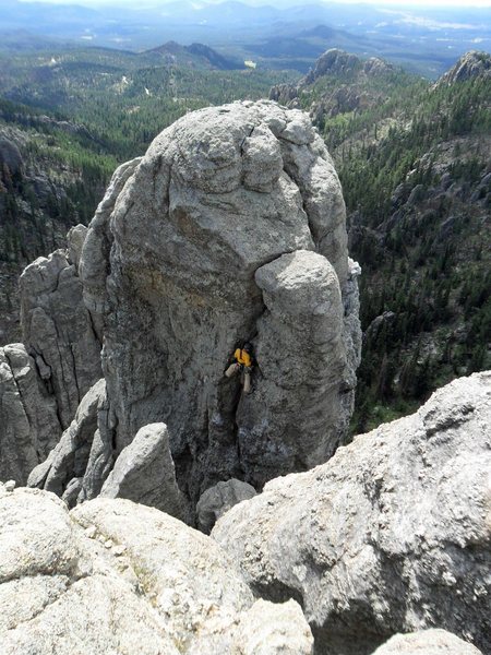 Jeff J. places gear in the crack before starting the crux of Balcony Point.  Photo taken from atop Spire 2.