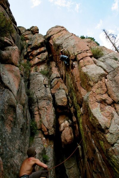 Matt Bruton Belaying Sean Stellick on the Contrivance.  This route and Chronometer on the arete to the right make this area fairly easy to identify.<br>
Photo by: Micah Morgan.