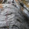 Tim getting to grips with the crux on The Voices Told Me, 5.9