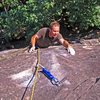 Derek Pearson doing the pumpy crux over the top bulge. (Just after unclipping a bolt.)